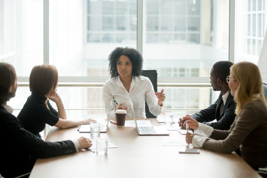 Woman of color leading corporate discussion